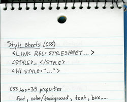 The top half of a loose-leaf spiral-bound notebook.  The page contains some simple notes about CSS, including the approximate number of properties and ways to associate CSS with HTML.