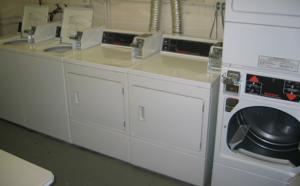 A pair of top-loading washing machines sit to the far left, a pair of front-loaders sit in the middle, and a stacked pair of front-loading dryers can be seen on the right.  They actually don't look like they're any different than normal washing machines.